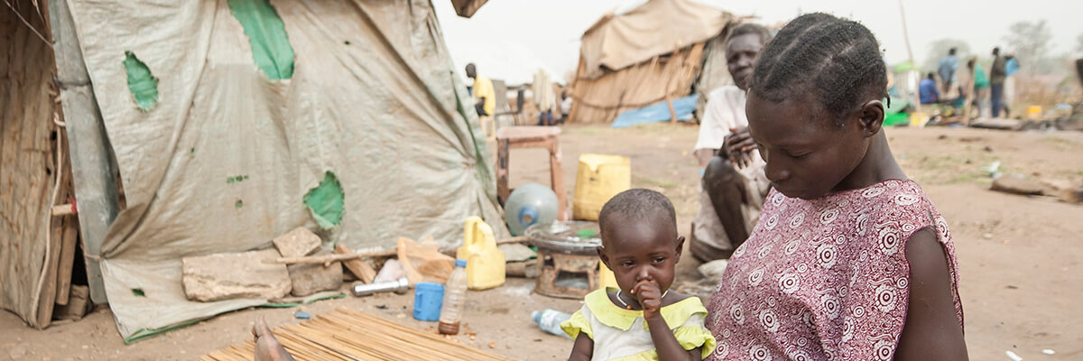 A teenage Sudanese girl with young girl