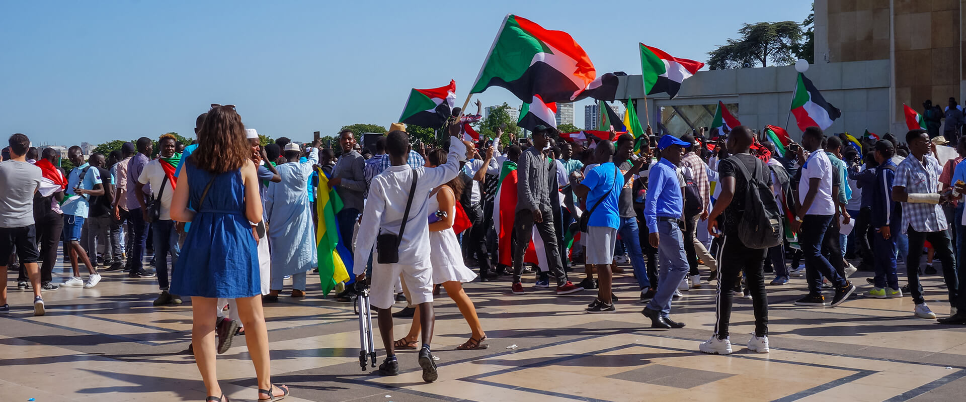 Sudanese community people with a flag of Sudan