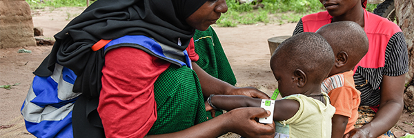 Sudanese woman treating infant