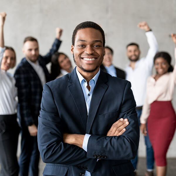People cheering in background behind a black businessman